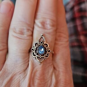 Intricate Silver Ring with Blue Teardrop Gem